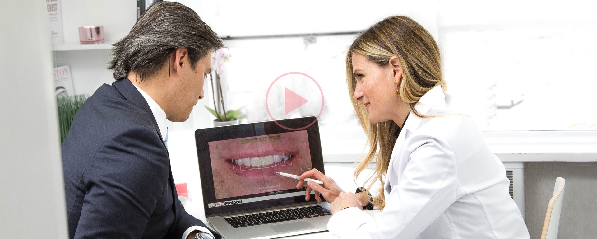 Dr Maria Cardenas with her patient at a laptop talking to him about his smile design with DSD dental treatment.