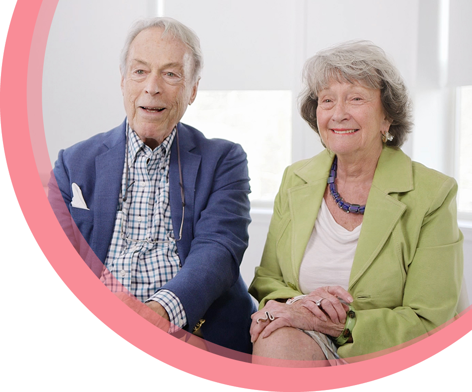 An older man and woman sit together at Maria Cardenas DMD dental clinic to talk about their experience as patients.
